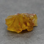 Fluorite jaune orange sur gangue rose de 25g